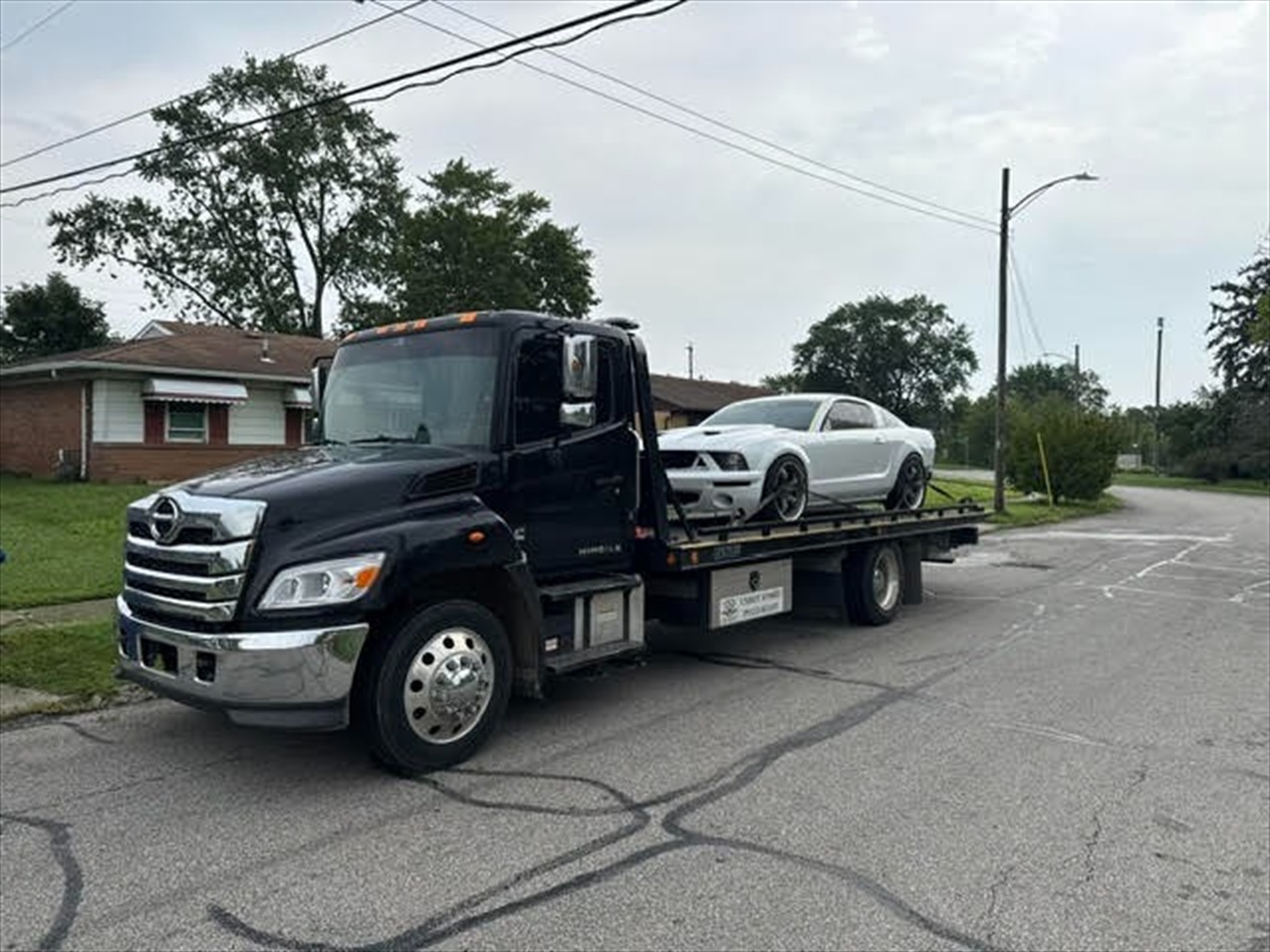 White sports car transport on flatbed