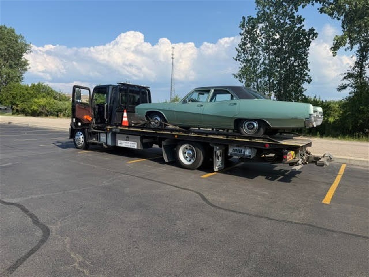 Mint green vintage sedan on flatbed